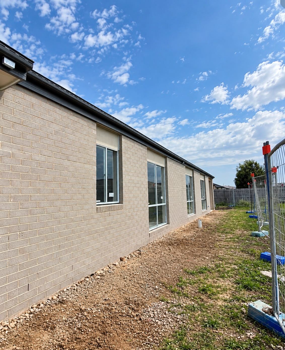 Side elevation of a completed brick veneer home with aluminium windows